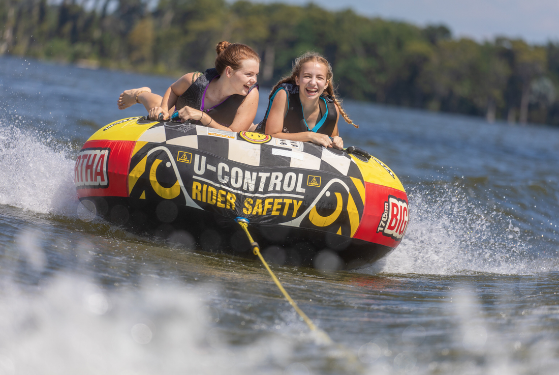 Picture of two girls tubing on the lake